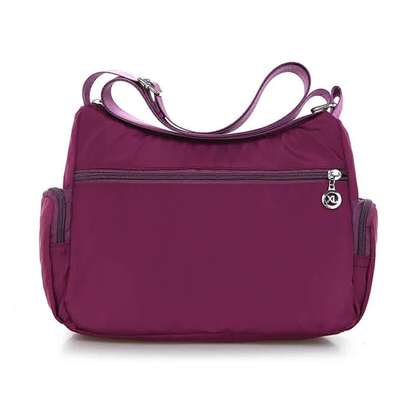 Back view of women’s purple nylon crossbody messenger bag with rear zip pocket
