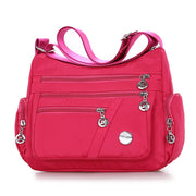 Women’s rose red nylon crossbody messenger bag with zippered pockets
