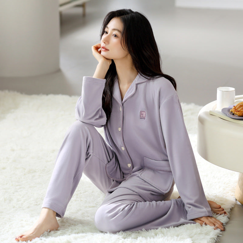 Woman wearing the Women's Premium Fleece Pajama Set in Lavender while relaxing at home
