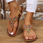 Women’s brown rhinestone flat sandals with colorful beaded straps, front view
