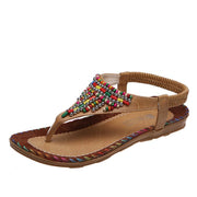 Women’s brown rhinestone flat sandals with comfortable Roman style design
