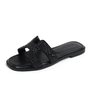 Women’s black rhinestone slide sandals with sparkling crystal embellishments
