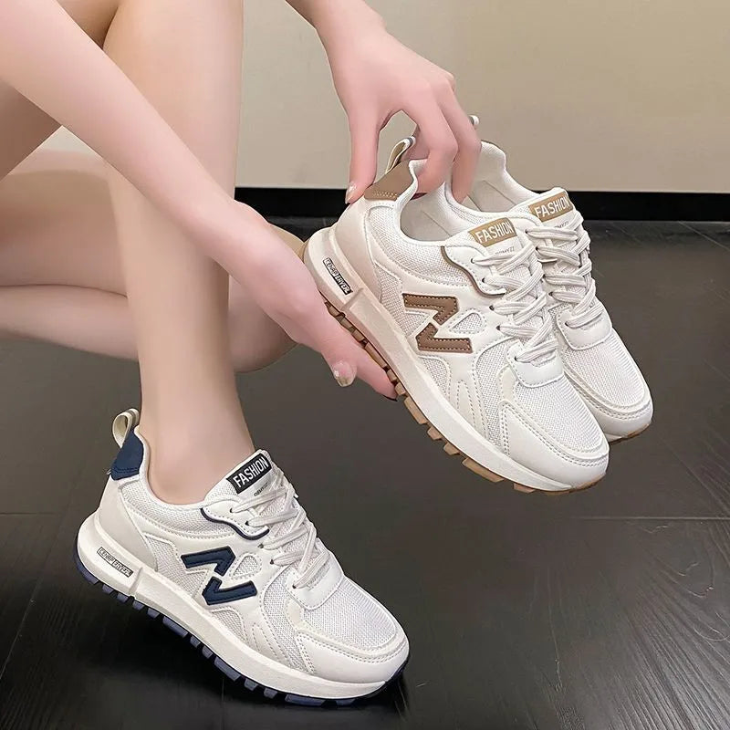 Woman wearing lightweight lace-up running sneakers with breathable mesh design.
