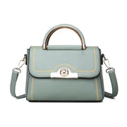 Sky blue structured crossbody handbag with gold-tone handle and elegant detailing.
