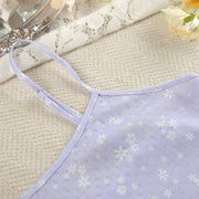 Close-up of the soft printed fabric and spaghetti strap detail on a women's pajama camisole.
