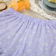 Elastic waist ruffle shorts detail from a women's printed pajama shorts set.
