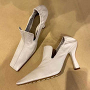Close up of white square toe mule heels with elegant stiletto heel
