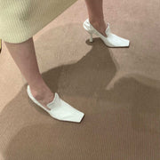 Women’s white square toe mule heels with elegant stiletto heel lifestyle
