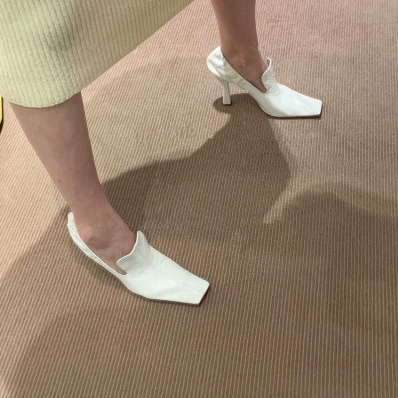 Women’s white square toe mule heels with elegant stiletto heel lifestyle

