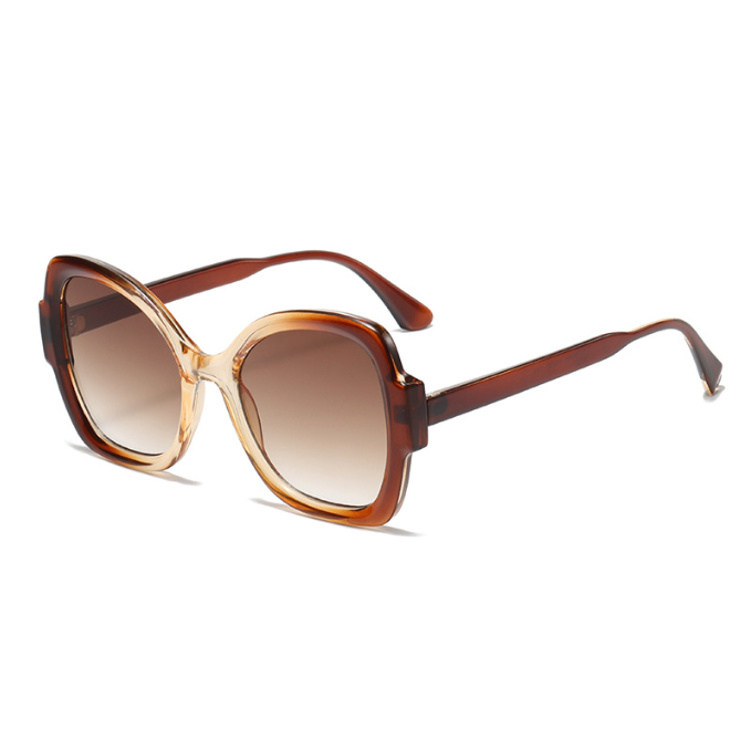 Women’s oversized UV400 sunglasses with gradual tea frame and fashion-forward oversized design.
